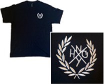 Black T-shirt with a white embroidered laurel-wreath logo on the left chest, with close-up